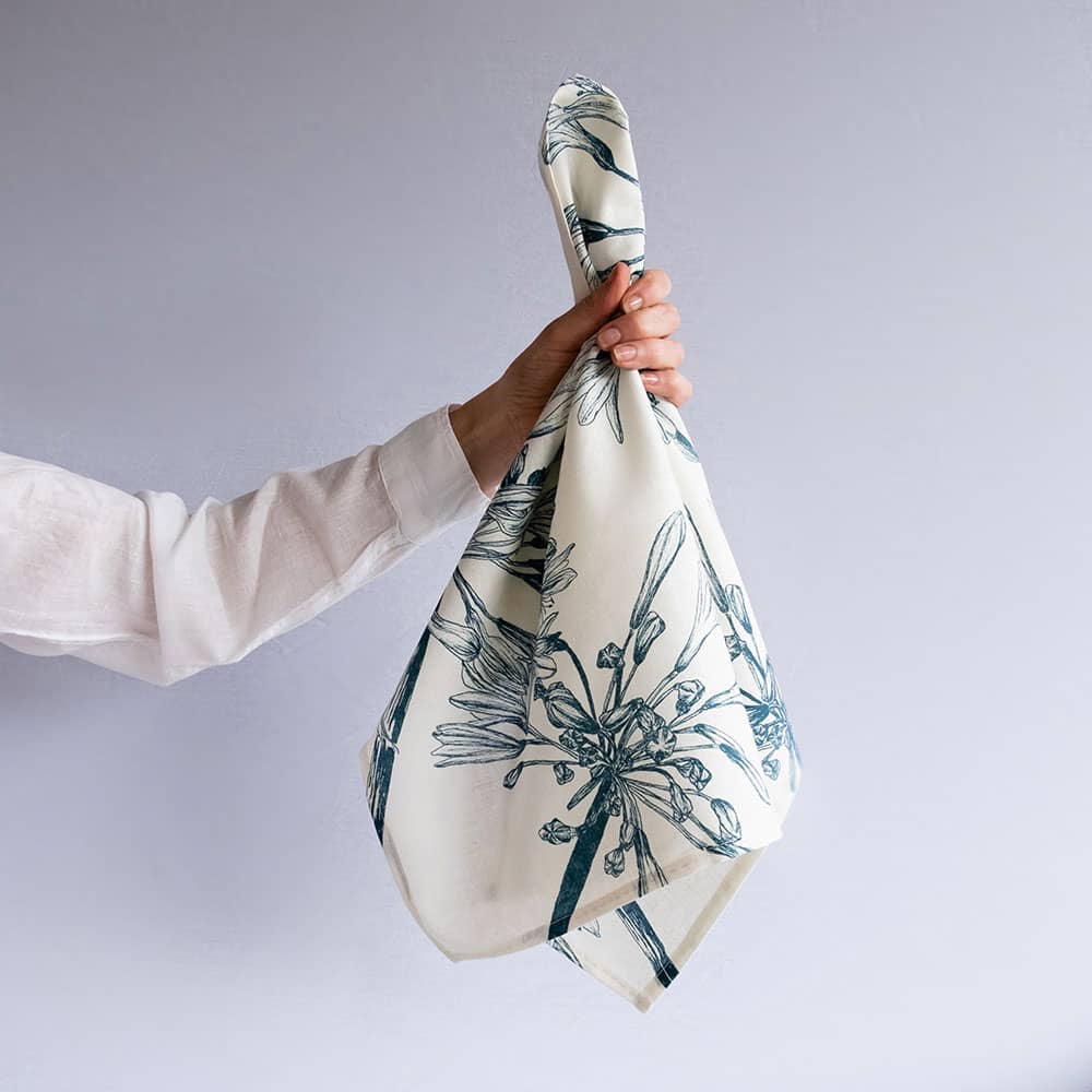 teal agapanthus design on a white tea towel